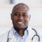 Head shot portrait of cheerful doctor in white uniform consulting patient online, looking at camera,